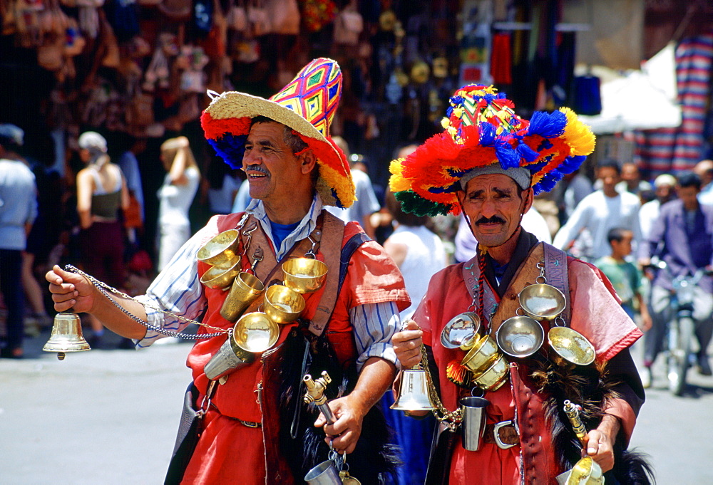 Water sellers in brightly coloured costumes in the Djemma El Fna square in Marrakesh, Morocco