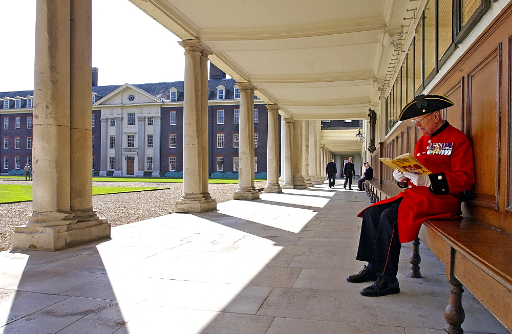 A Chelsea pensioner sitting outside the Royal Hospital Chelsea, London