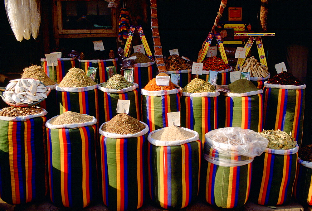 Brightly coloured sacks of spices and nuts on sale in the Souk in Cairo, Egypt