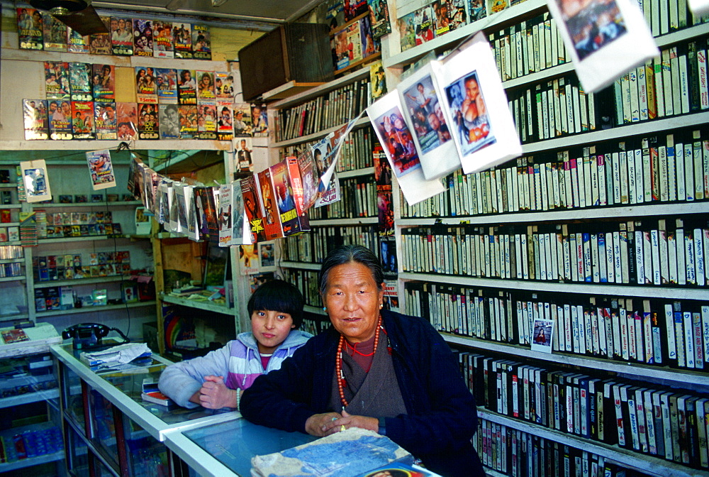 Woman and child in video shop, Paro, Bhutan