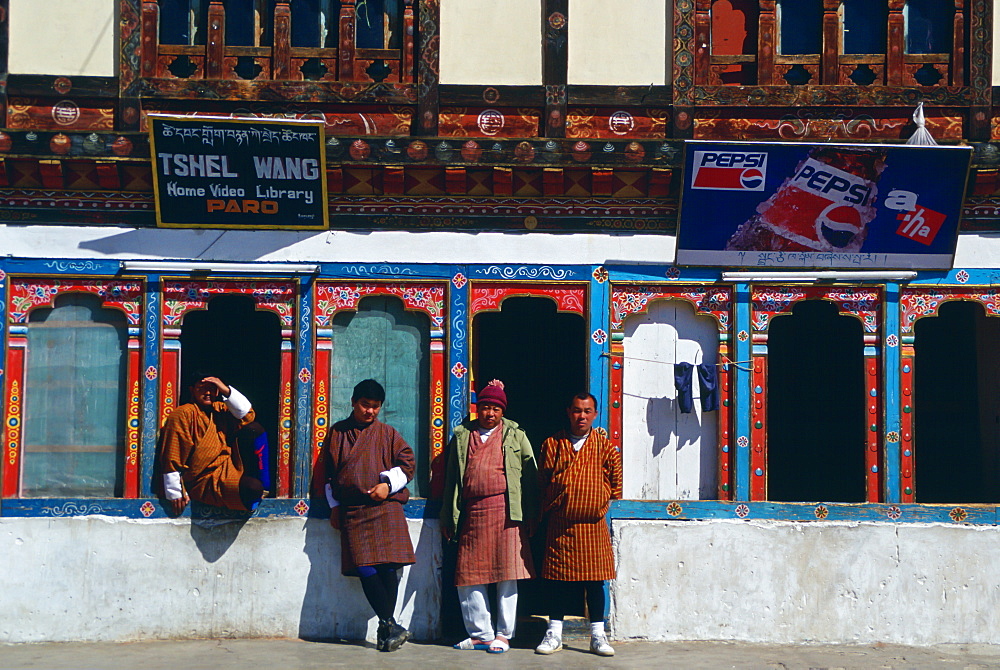 Bhutanese men at general stores shop which sells Pepsi and  rents out home videos in Paro, Bhutan