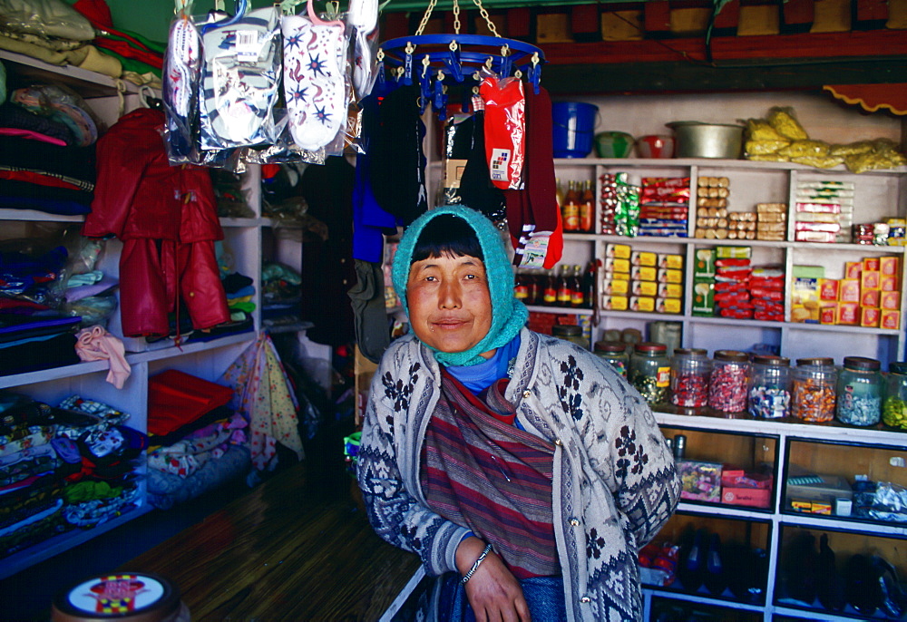 A woman storekeeper in a general store in Bhutan