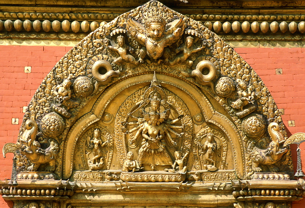 Intricate carvings on the ornate golden gate entrance to Bhaktapur Palace in Nepal