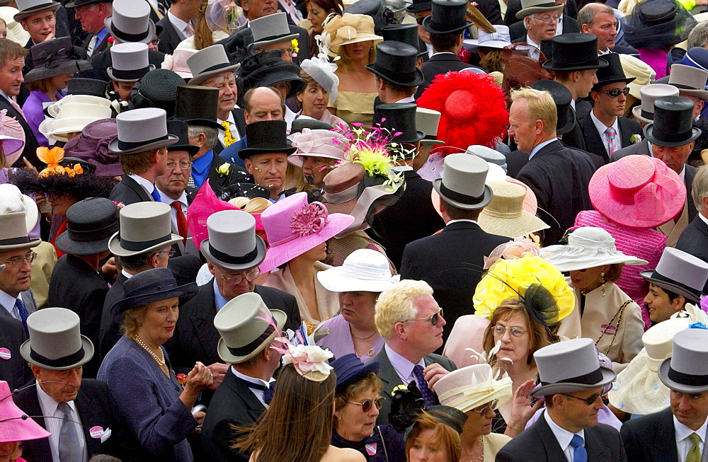 Crowd of racegoers in traditional top hats, tails and dramatic fashions at Royal Ascot Races