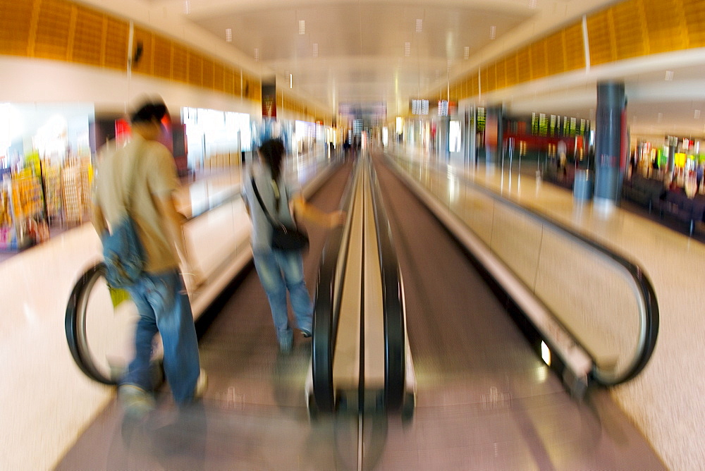 Commuters on an airport conveyor belt , Australia