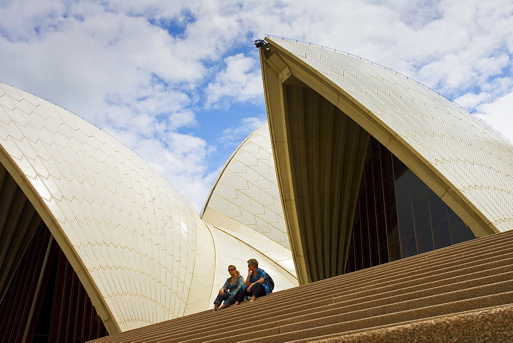 Tourists sit on the steps infront of the Sydney Opera House, Australia