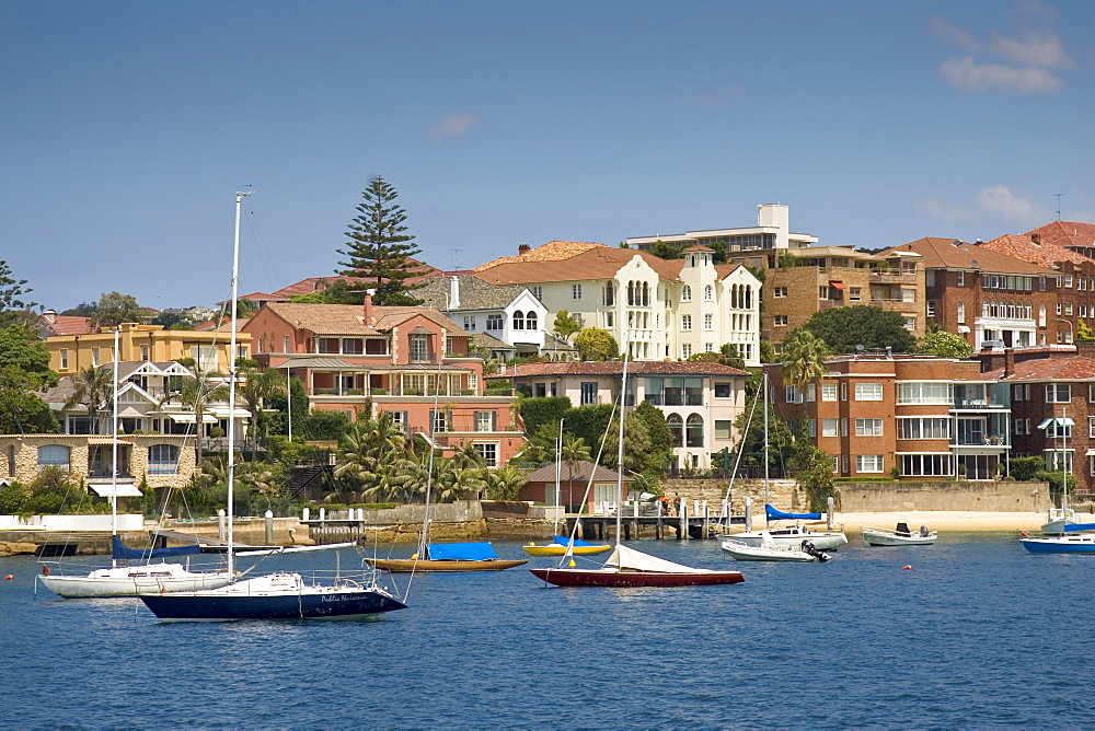 Yachts moored, Sydney Harbour waterfront residences near Point Piper, Double Bay, Australia