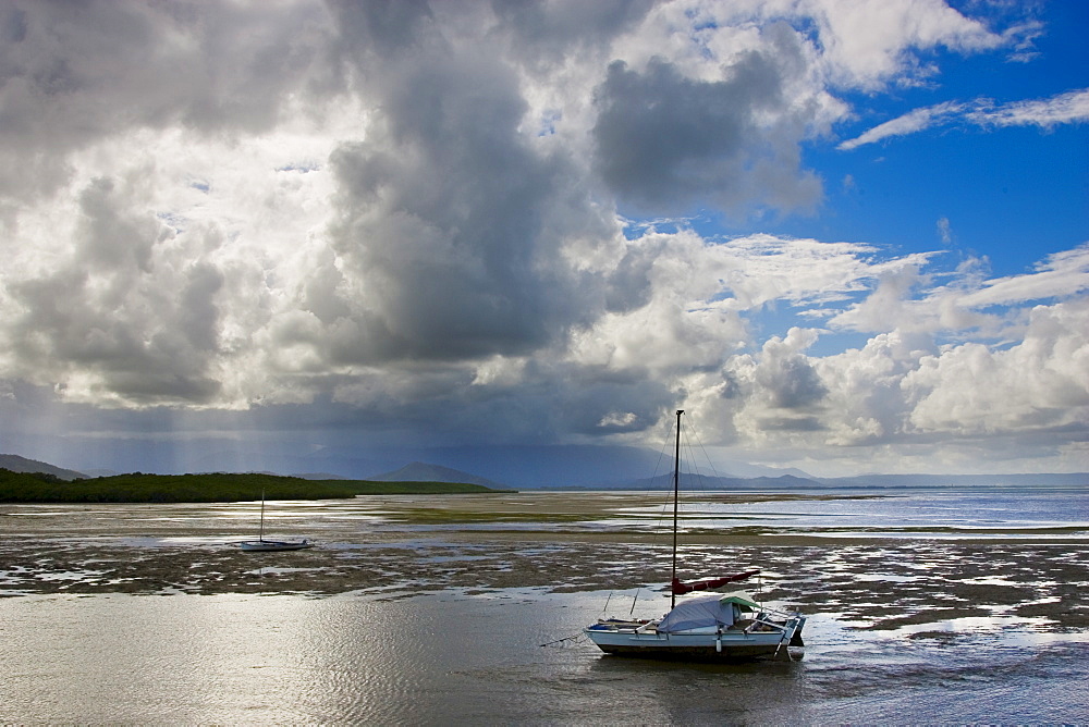 Sailing boat moored at low tide in the Port Douglas estuary, Queensland, Australia