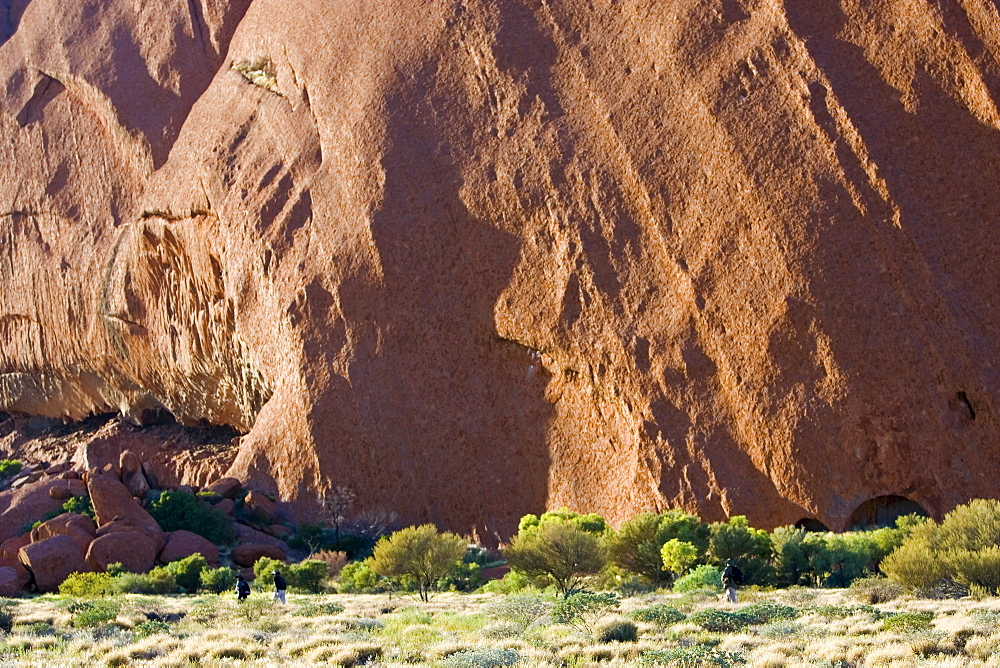 Tourists at the base of Ayers Rock, Uluru, Australia