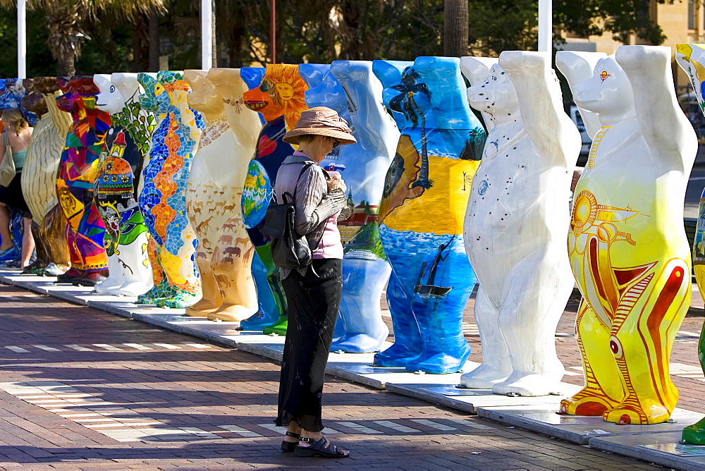 Tourist admires the Unicef charity fundraising United Buddy Bears in Sydney, New South Wales, Australia