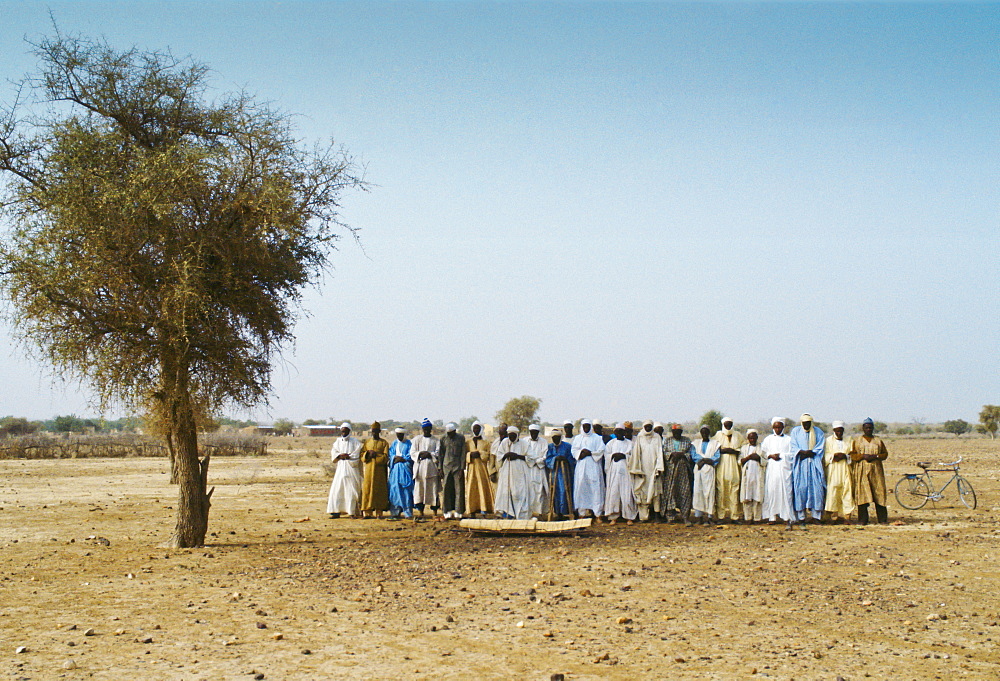 Muslims pray to the east during a  funeral in the desert, Burkina Faso, formerly Upper Volta, Africa