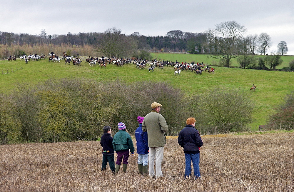 A family gather to watch the Heythrop New Year's Day Hunt as it crosses the Stow-on-the-Wold fields in Oxfordshire