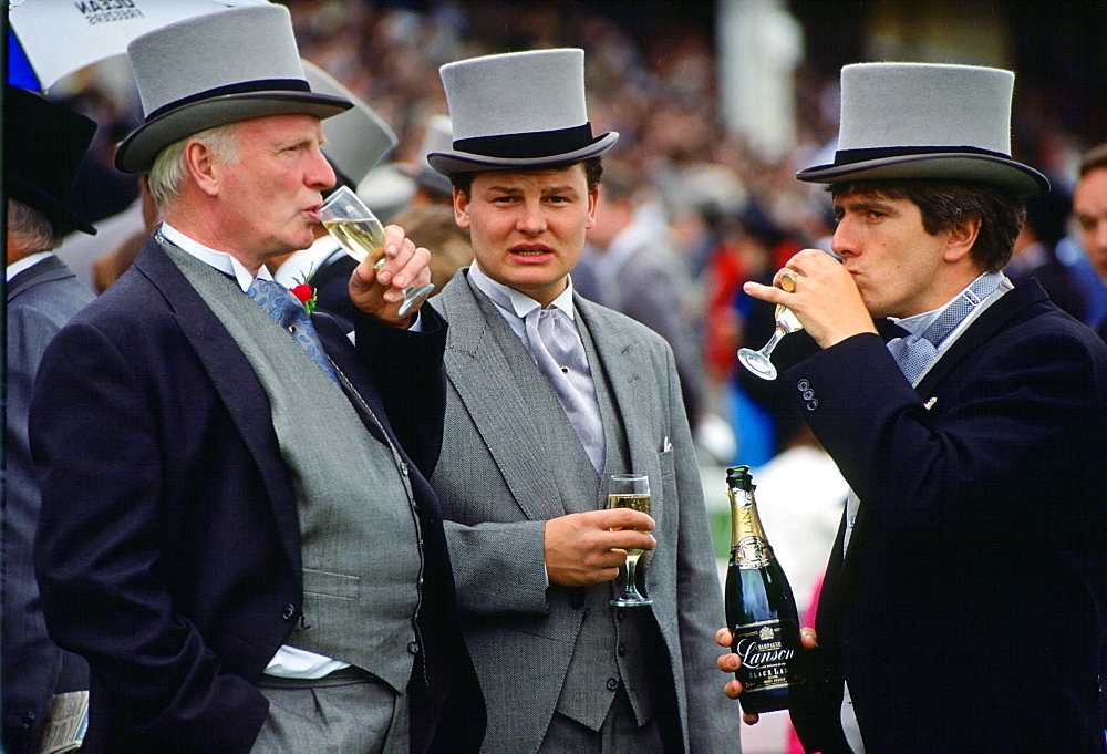 Racegoers drinking champagne at the Epsom Derby, Surrey