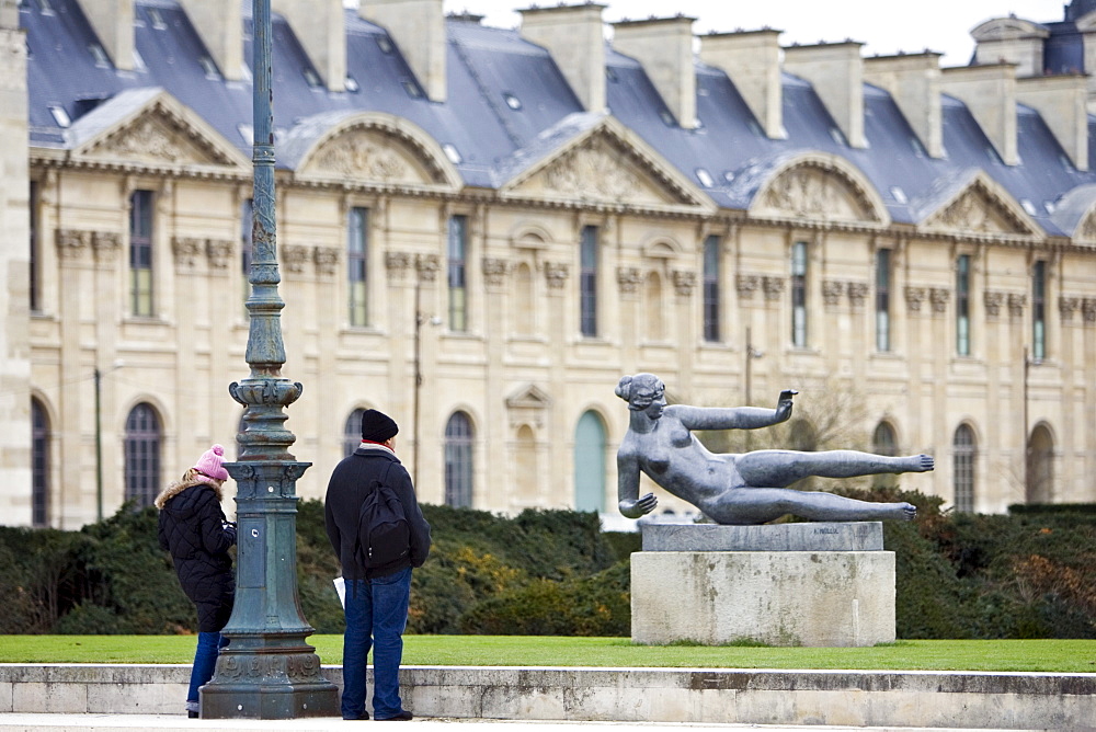 Visitors admire bronze sculpture statue of reclining nude by Maillol in Jardin in front of the Louvre in the Jardin des Tuileries, Central Paris, France