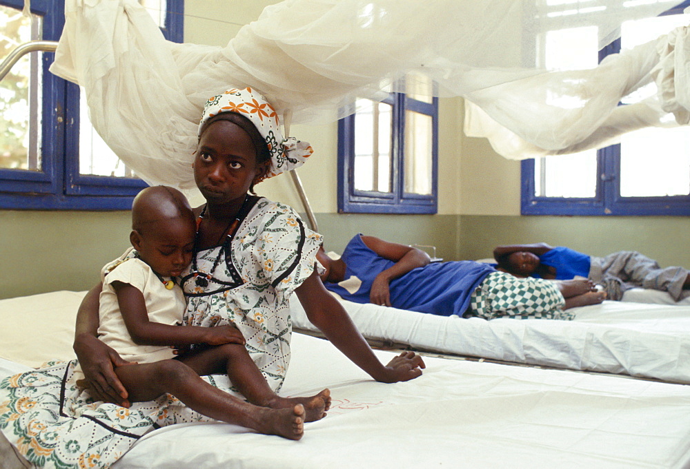 A young mother and her child in Basse Health centre, Gambia