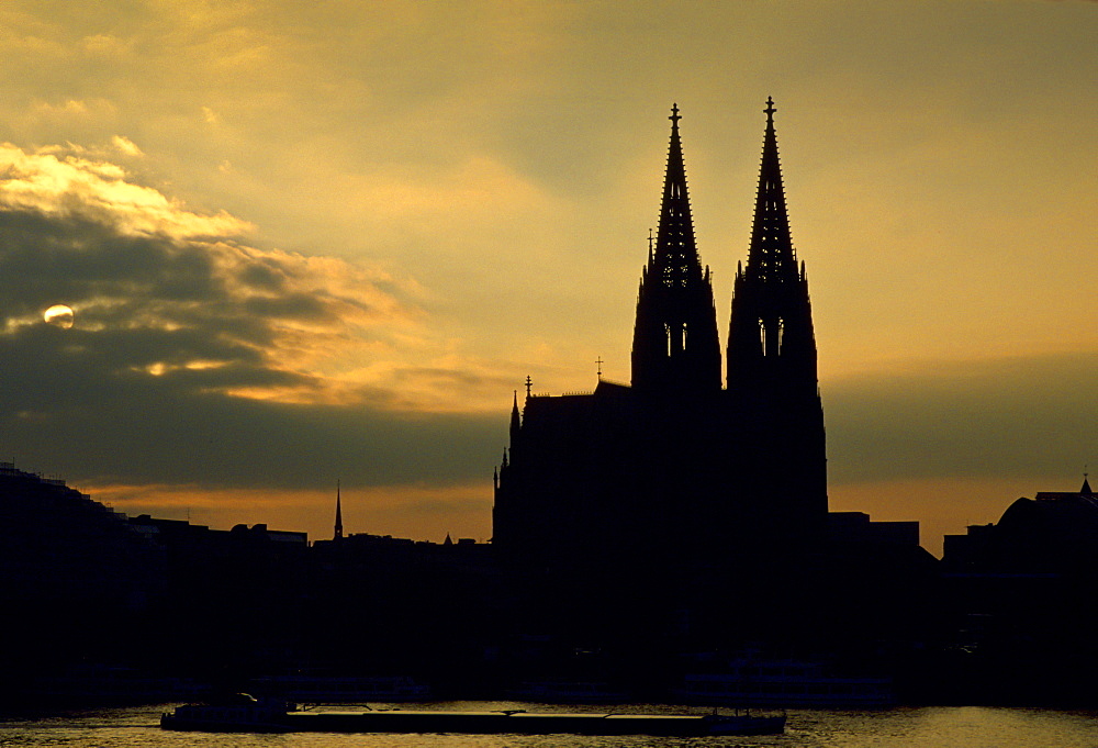 A cathedral in Cologne by the Rhine at sunset, Germany