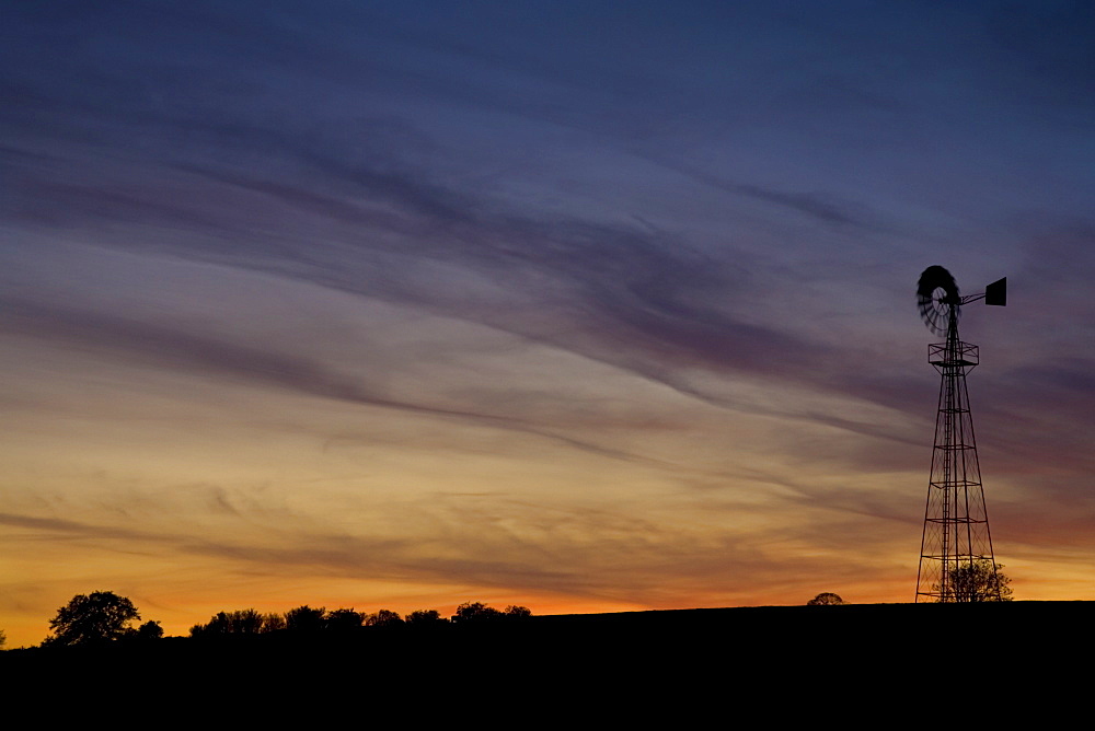 Aeromotor windmill against red sky, England, United Kingdom