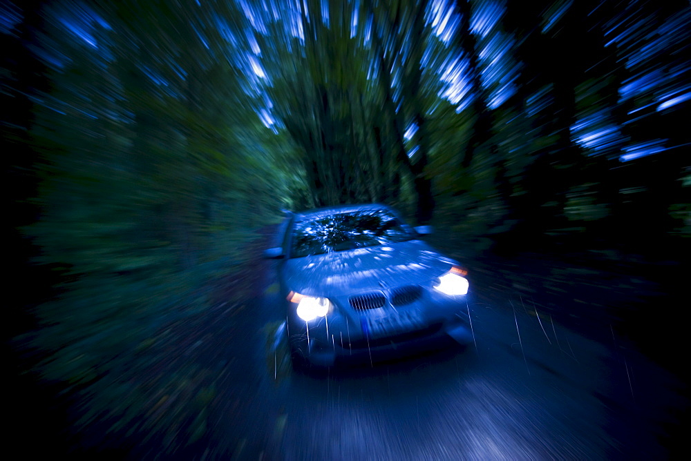 BMW car on country road at night, Gloucestershire, United Kingdom