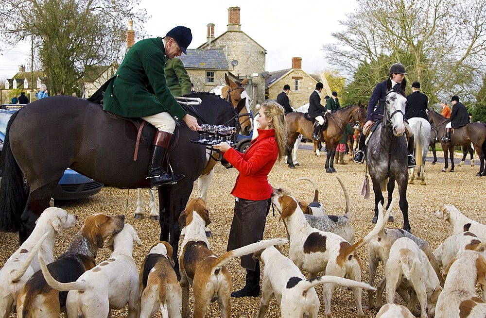 Members of Heythrop Hunt are offered drinks outside the Westcote Inn, Oxfordshire, United Kingdom