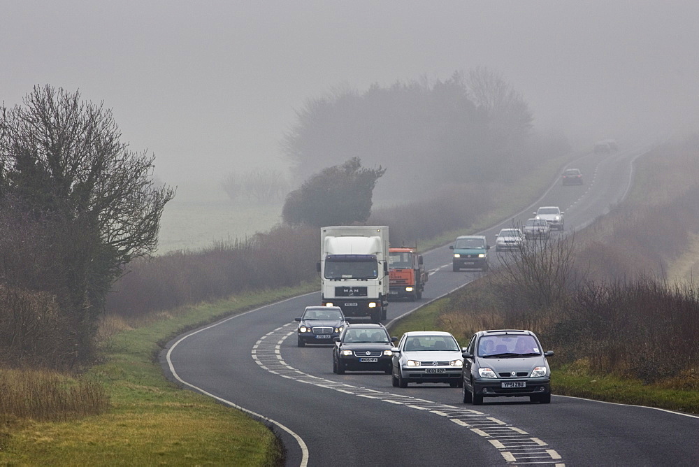 Cars and lorry drive along foggy road, Oxfordshire,  United Kingdom