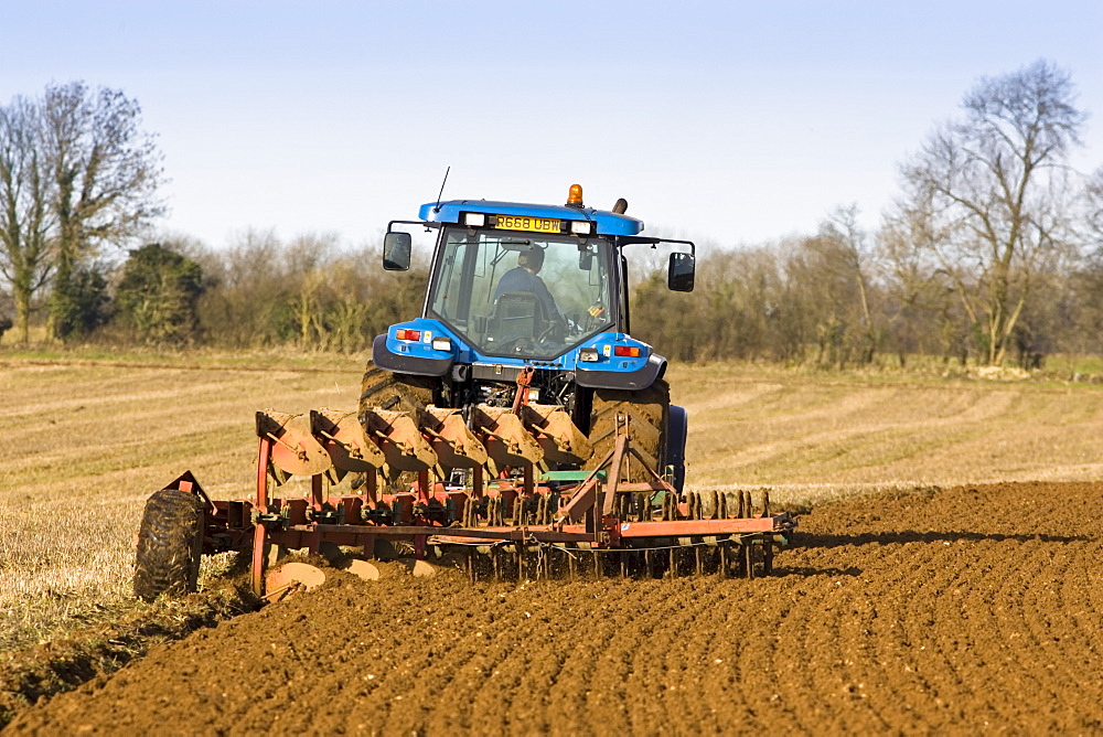 Tractor ploughing field in Oxfordshire, The Cotswolds, United Kingdom