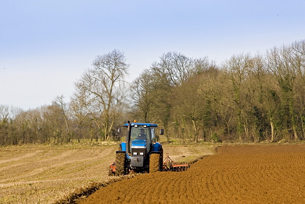 Tractor ploughing field in Oxfordshire, The Cotswolds, United Kingdom