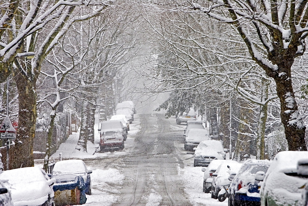 Cars parked in a snow-covered Hampstead street, North London, England, United Kingdom