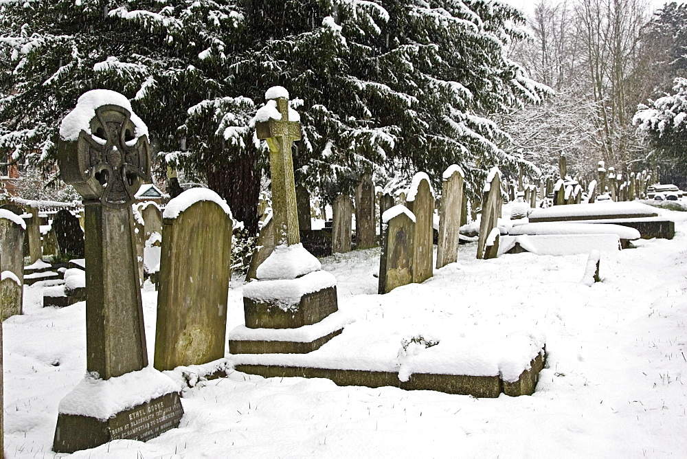 Snow covered gravestones in Hampstead Parish churchyard, London, United Kingdom