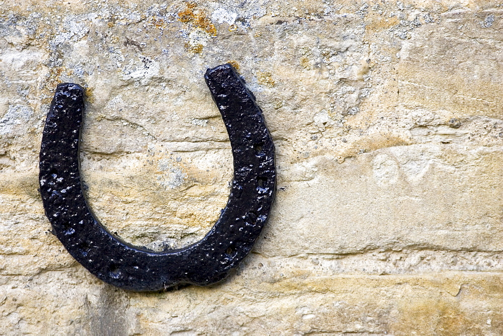 Horseshoe on a Cotswold stone wall farmhouse, Oxfordshire, United Kingdom