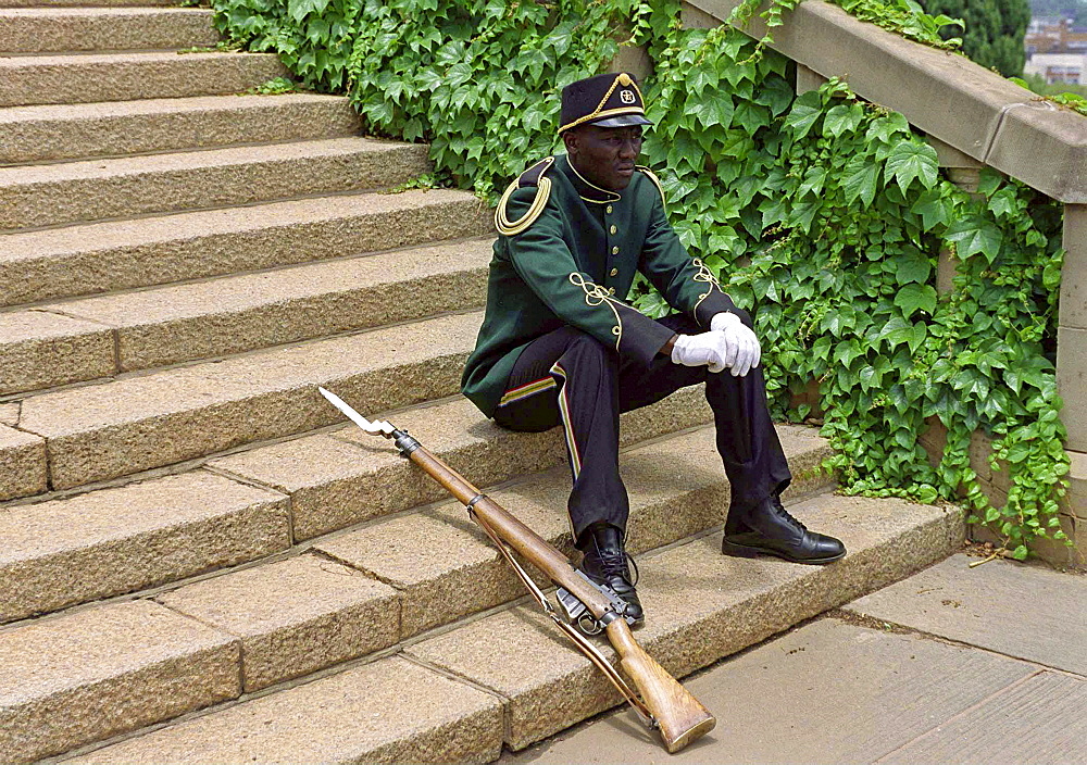 A CEREMONIAL GUARD TAKES A REST AT UNION BUILDINGS, PRETORIA, SOUTH AFRICA