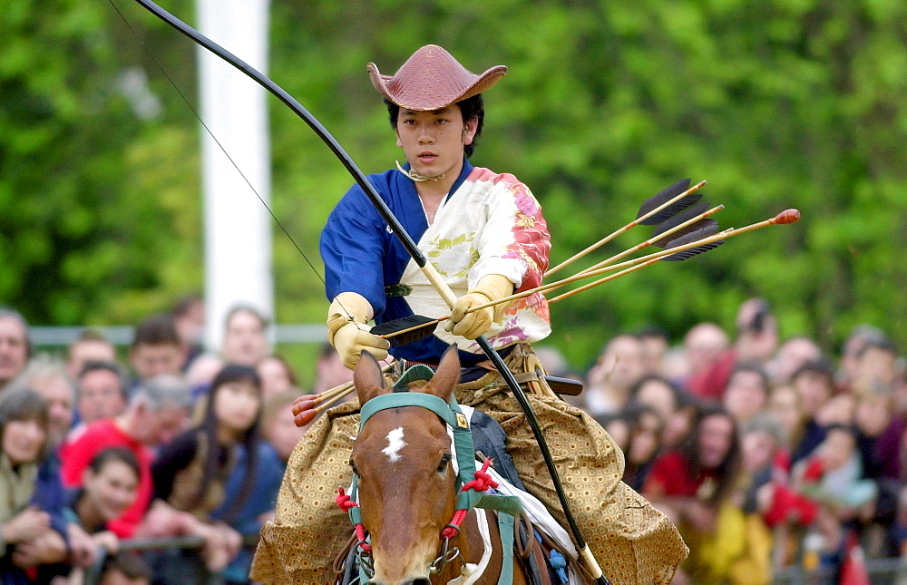 Japanese horseman displaying his skill with bow and arrows at the japanese exhibition matsuri japan in the park in hyde park, london.