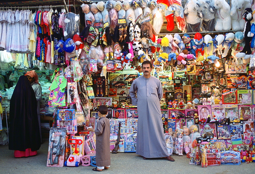 Small child gazing at toys in the market, Kuwait