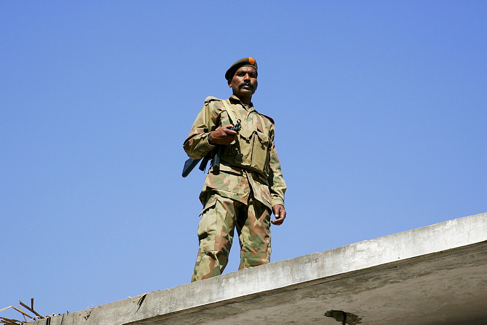 Armed Pakistani soldier on duty in village of Pattika, Pakistan