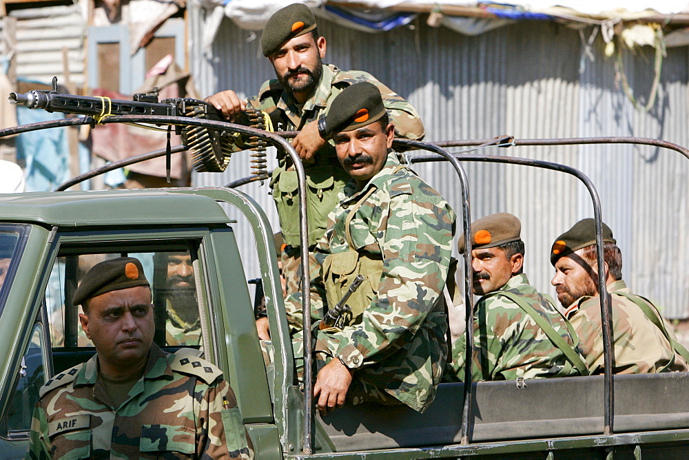 Armed Pakistani soldiers in open top vehicle with machine gun in village of Pattika, Pakistan