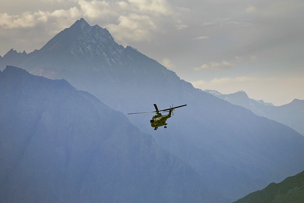 Helicopter flies through valleys of Karokoram Mountains, Skardu Valley, North Pakistan