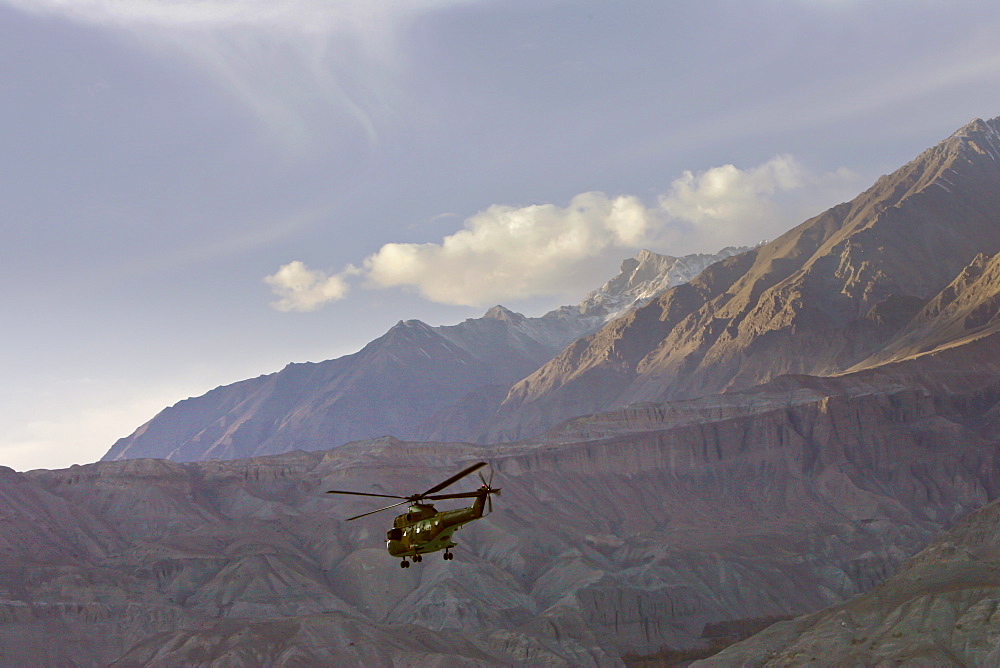 Helicopter flies through valleys of Karokoram Mountains, Skardu Valley, North Pakistan