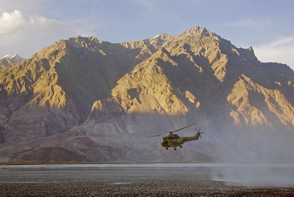 Helicopter flies through valleys of Karokoram Mountains, Skardu Valley, North Pakistan