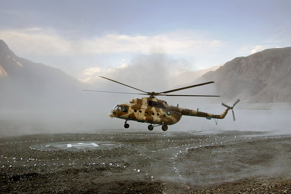 Helicopter landing on heliport in valleys of Karokoram Mountains, Skardu Valley, North Pakistan