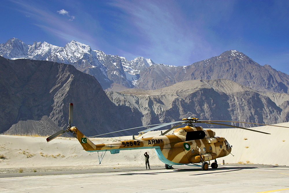 Helicopter on heliport in valleys of Karokoram Mountains, Skardu Valley, North Pakistan