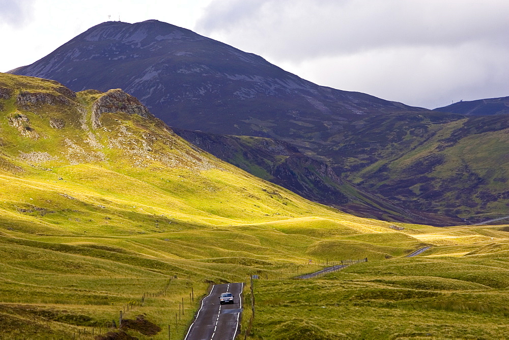 Car drives through the Glen Clunie hills and Grampian Mountains, Scotland, United Kingdom