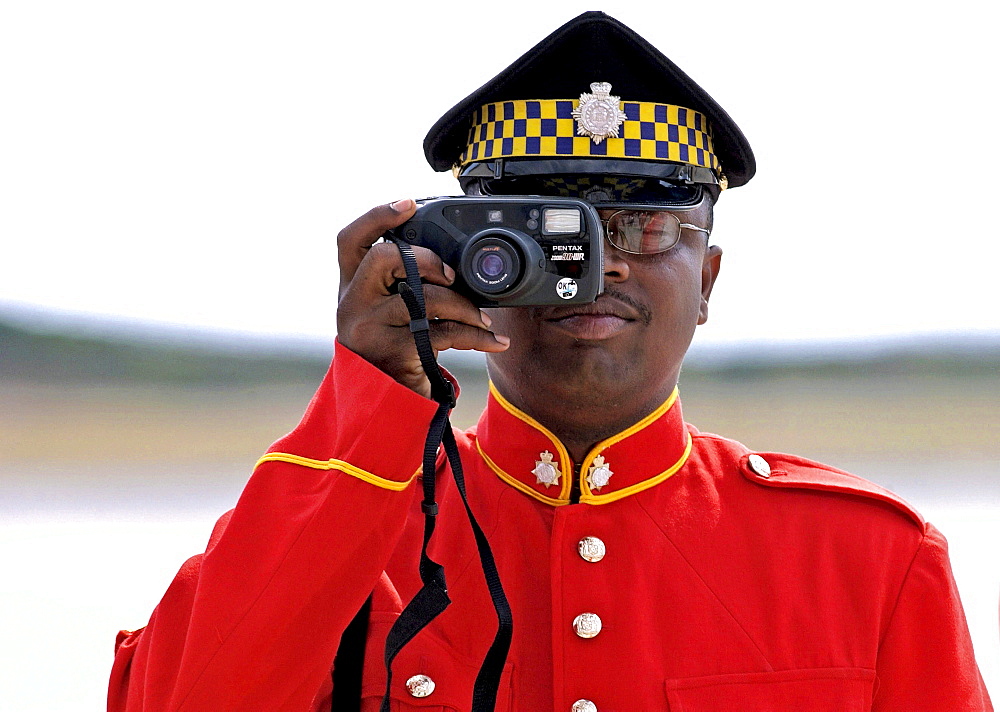 Soldier from the Jamaica Defence Force taking a photograph during parade