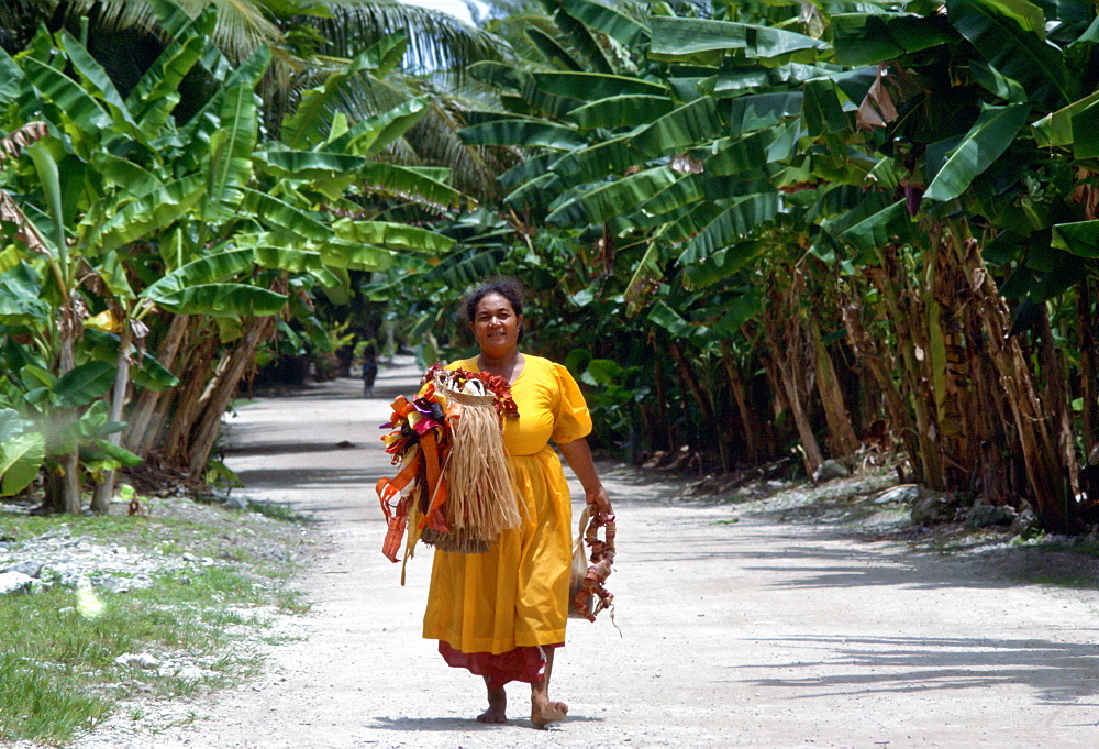 Woman walking down the main street of Tuvalu, South Pacific