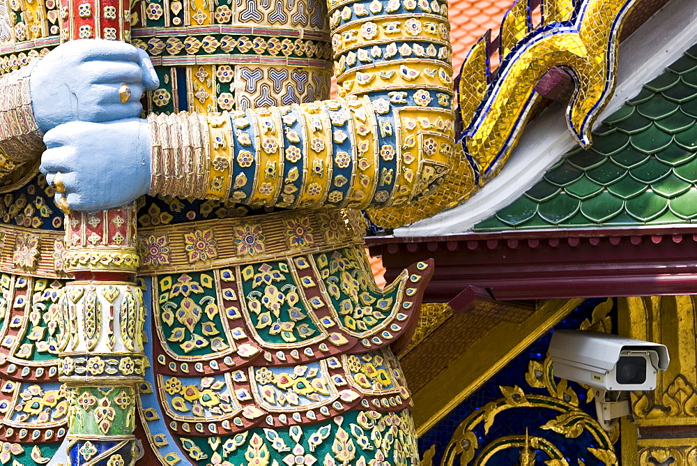 CCTV camera behind a Demon Giant statue in The Grand Palace Complex, Bangkok, Thailand