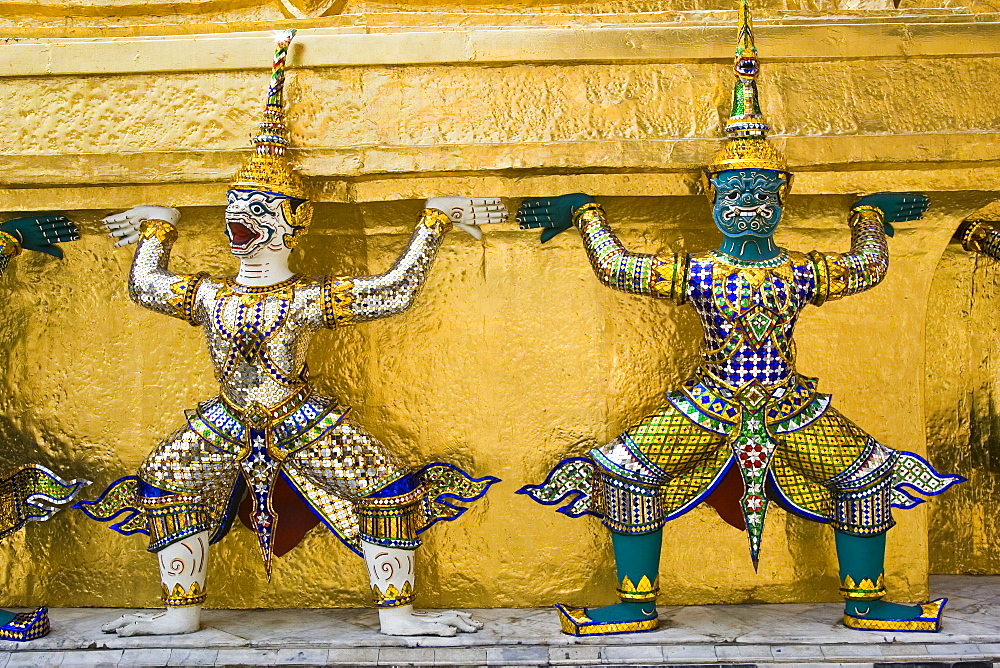 Guardian sculptures at the base of a Golden Chedis, Bangkok, Thailand