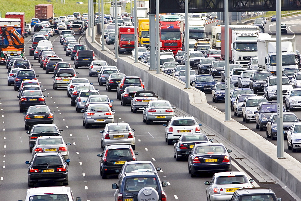 Traffic congestion of cars and lorries travelling in both directions on M25 motorway, London, United Kingdom