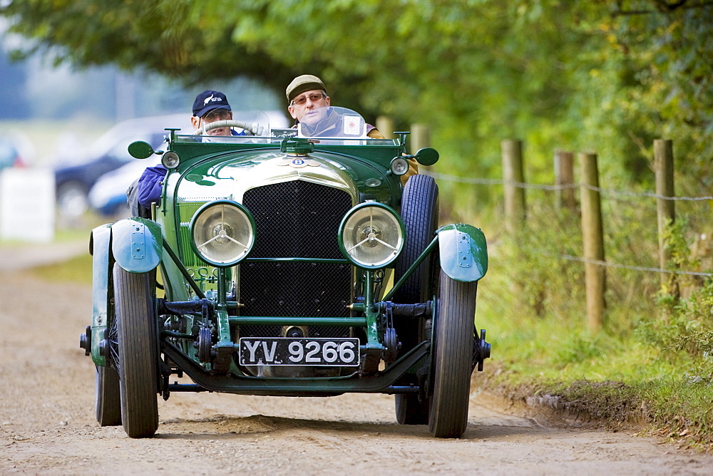 Vintage Bentley convertible sports car being driven in Charlton Park, Wiltshire, UK