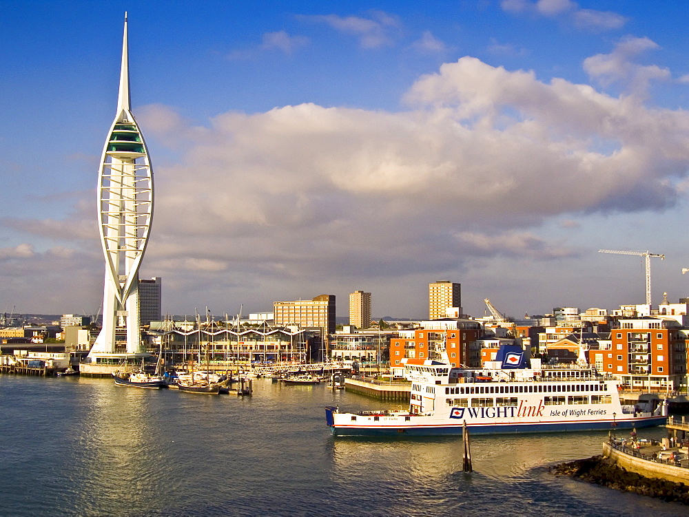 Isle of Wight Ferry boat passes Spinnaker Tower in Portsmouth Harbour, England