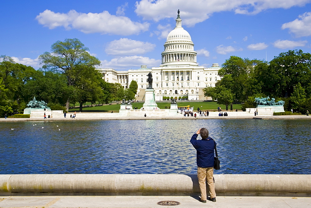 Tourist takesphotograph of The United States Capitol, Washington DC, United States of America