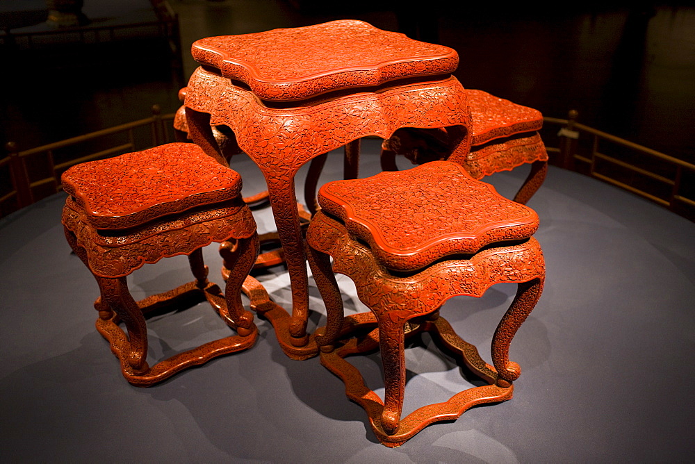 Red lacquer square table and stools with carved floral design on display in the Shanghai Museum, China