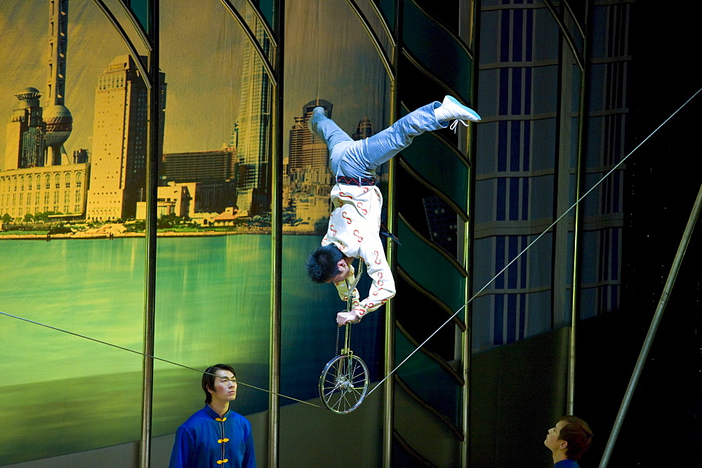 Shanghai Acrobatic Group perform a balancing act stunt on a tightrope, Shanghai Centre Theatre, China